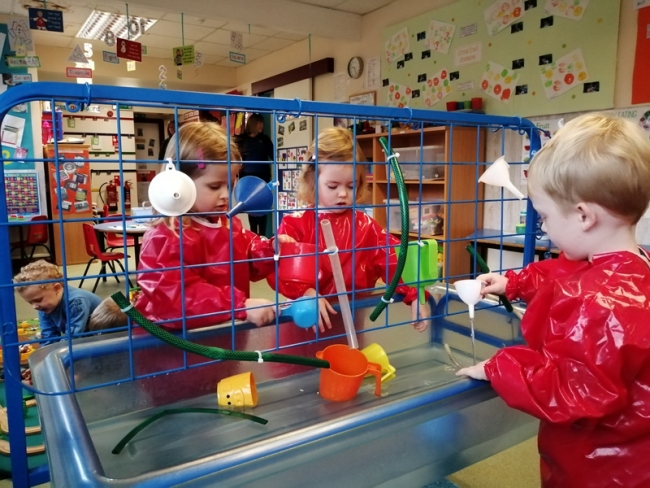Children Playing in the water tray